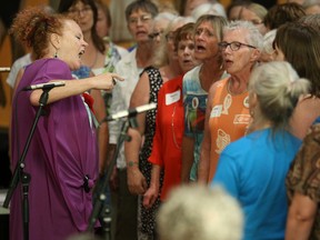 Georgette Fry (far left) sings along with the combined choirs of Picton, Kingston and Brockville during the 15th anniversary party for Shout Sister! on Saturday August 19, 2017 in Belleville, Ont. Tim Miller/Belleville Intelligencer/Postmedia Network