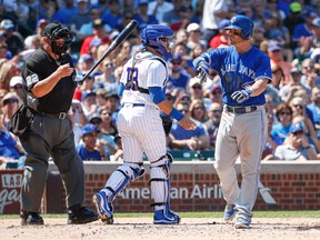 Toronto Blue Jays' Steve Pearce, right, throws his bat after striking out against the Chicago Cubs during the third inning of a baseball game, Saturday, Aug. 19, 2017, in Chicago. (AP Photo/Kamil Krzaczynski)