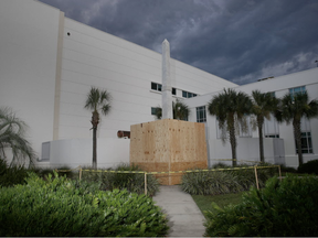 Plywood covers part of a statue that shows two figures of Confederate soldiers in front of the Hillsborough Country Courthouse as the city plans to move the statue in the midst of a national controversy over whether Confederate symbols should be removed from public display on August 18, 2017 in Tampa, Florida. (Joe Raedle, Getty Images)