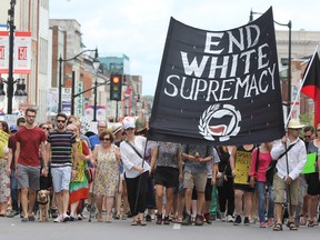 The Kingston Anti-fascist Solidarity Memorial Parade walks against traffic on Princess Street in Kingston, Ont. on Saturday August 19, 2017. Steph Crosier/Kingston Whig-Standard/Postmedia Network