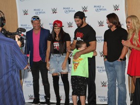 Make-A-Wish recipients are greeted by WWE superstars Dolph Ziggler, left to right, Nikki Bella, Seth Rollins, AJ Styles and Dana Warrior on the 102nd floor of One World Observatory in New York City on Saturday. (George Tahinos/SLAM! Wrestling)