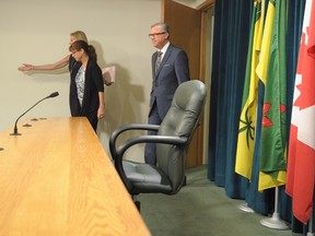 Premier of Saskatchewan Brad Wall, his wife Tammy, and chief of operations and communications Kathy Young, back, enter a press conference where Wall announced he is retiring from politics at the Legislative Building in Regina, Sask., on Thursday, August 10, 2017. THE CANADIAN PRESS/Mark Taylor