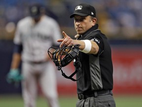 Home plate umpire Chris Guccione points to Tampa Bay Rays' Kevin Kiermaier during the first inning of a baseball game Saturday, Aug. 19, 2017, in St. Petersburg, Fla. (AP Photo/Chris O'Meara)