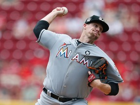Miami Marlins starting pitcher throws against the Cincinnati Reds during the first inning of a baseball game, Sunday, July 23, 2017, in Cincinnati. (AP Photo/Gary Landers)