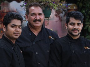 Parkash Chhibber (centre) stands with members of his staff Purvak Patel (left) and Abhishek Gaekwad (right) outside his restaurant, Indian Fusion - The Curry House at 10322 111 St. in Edmonton, Alta. on Saturday, Aug. 19, 2017. Chhibber began offering free meals to those in need out of the back of his restaurant three years ago, the same food he serves to his paying customers, and now serves as many as 1,600 hot meals to those in need every month. CLAIRE THEOBALD/POSTMEDIA