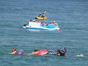 Participants in the St. Clair River float down held out into the river at the start of the event Sunday Aug. 20, 2017. Canadian Coast Guard officials estimated 100 people left from the Canadian side. A larger group launched from the beach at the lighthouse on the Michigan side of the waterway.