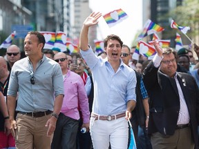 Prime Minister Justin Trudeau (centre), Irish Taoiseach Leo Varadkar (left) and Montreal Mayor Denis Coderre take part in the annual pride parade in Montreal on Sunday, Aug. 20, 2017. (Graham Hughes/The Canadian Press)