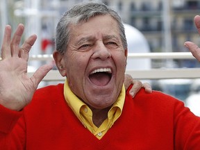 Jerry Lewis raises his hands on May 23, 2013 while posing during a photocall for the film "Max Rose" presented Out of Competition at the 66th edition of the Cannes Film Festival in Cannes. (VALERY HACHE/AFP/Getty Images)