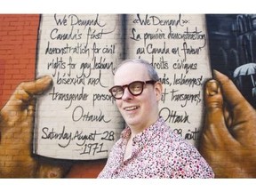 Glenn Crawford stands in front of a mural at the corner of Bank and Gilmour Street. Darren Brown/Postmedia