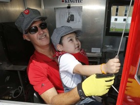 Jake Amarualik, an Inuit boy from Nunavut, and CP employee Dave Sobol toot the horn on a mini train as part of his wish to meet a train conductor on Sunday, August 20, 2017. PATRICK DOYLE