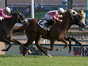 Jockey Rafael Hernandez (2) guides Channel Maker at the Breeders' Stakes, in Toronto on Sunday, August 20, 2017. (THE CANADIAN PRESS/HO-Woodbine Racetrack, Michael Burns)