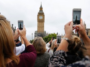 People record the last bell bong at Elizabeth Tower in London, Monday, Aug. 21, 2017. (AP Photo/Frank Augstein)