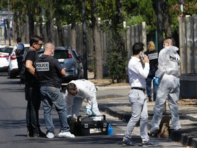 French police officers work near a bus stop in La Valentine district after a van rammed into two bus stops in the French port city of Marseille, southern France, Monday Aug.21, 2017. (AP Photo/Claude Paris)