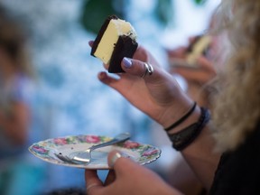 Elle Postin, of England, eats an ice cream during the second stop on a gourmet ice cream food tour in Vancouver, B.C., on Thursday August 17, 2017. THE CANADIAN PRESS/Darryl Dyck
