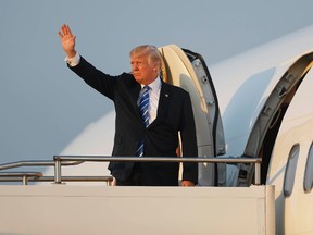 President Donald Trump waves while boarding Air Force One at Morristown Municipal Airport, Sunday, Aug. 20, 2017, in Morristown, N.J., for the return flight to the Washington area. (AP Photo/Pablo Martinez Monsivais)
