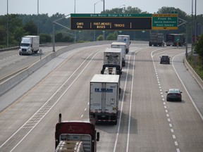 A line of slowing-moving trucks heads for America. Such situations have been the scene of three transport-truck collisions on Highway 402 during the past month. (NEIL BOWEN/Sarnia Observer)