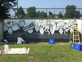 Aida Sulcs works on her piece for the “On the Wall” street art festival Monday morning. (Peter Hendra/The Whig-Standard)