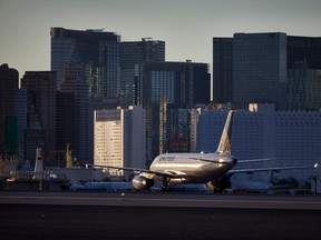 In this May 16, 2016, photo, a plane taxis toward the terminal after landing at McCarran International Airport in Las Vegas. (AP Photo/John Locher)