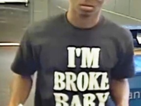 This frame grab image from video provided by the Lee's Summit Police Department, in Lee's Summit, Mo., shows a man accused of stealing a TV while wearing a T-shirt with the phrase "I'm Broke Baby" on it. The Lee's Summit Police Department said on its Facebook post that he's suspected of stealing the large TV from a retailer. It doesn't say when the theft occurred. (Lee's Summit Police Department via AP)