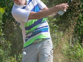 Ross Muir hits out of a sand trap on the 2nd hole as the Sun Scramble Media Challenge kicks off at Manderley on the Green on Aug. 21, 2017. (Wayne Cuddington/Postmedia)