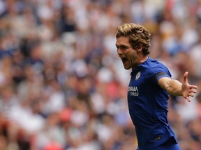 Chelsea's Marcos Alonso celebrates after scoring the game-winning goal against Tottenham on Sunday. (AP)