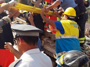 Firefighters and rescuers pull out a boy, Mattias, from the collapsed building in Casamicciola, on the island of Ischia, near Naples, Italy, a day after a 4.0-magnitude quake hit the Italian resort island, Tuesday, Aug. 22, 2017. (Italian Carabinieri, HO/ANSA via AP)