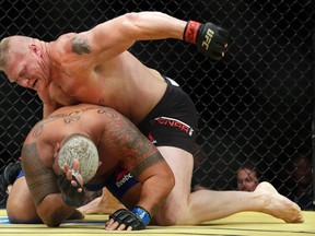 In this July 9, 2016, file photo, Brock Lesnar, top, fights Mark Hunt during their heavyweight mixed martial arts bout at UFC 200 in Las Vegas. (AP Photo/John Locher, File)