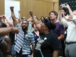 Protesters yell during the Charlottesville City Council meeting Monday, Aug. 21, 2017, in Charlottesville, Va. (Andrew Shurtleff/The Daily Progress via AP)