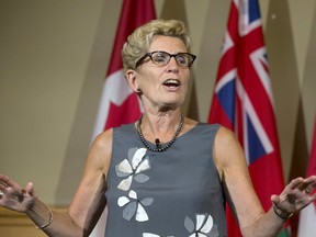 Premier Kathleen Wynne speaks at Queen's Park in Toronto on Aug. 17, 2017. (STAN BEHAL/TORONTO SUN)