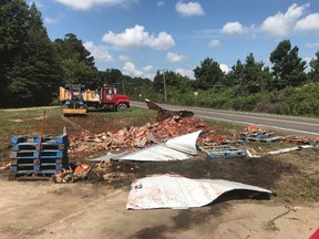 In this Monday, Aug. 21, 2017, photo provided by the Camden News, broken jars of spaghetti sauce litter a road near Camden, Ark. (Shantelle Laughlin/Camden News via AP)