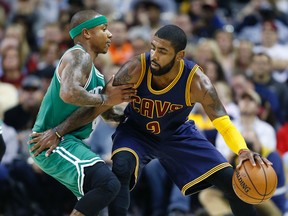 In this Nov. 3, 2016, file photo, Cleveland Cavaliers' Kyrie Irving, right, looks to drive against Boston Celtics' Isaiah Thomas during the first half of an NBA basketball game in Cleveland. (AP Photo/Ron Schwane, File)