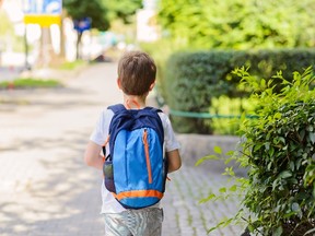 In this stock photo, a young boy walks to school carrying a backpack. (Getty Images)
