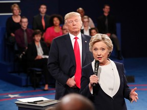 In this Oct. 9, 2016 file photo, Democratic presidential nominee Hillary Clinton, right, speaks as Republican presidential nominee Donald Trump listens during the second presidential debate at Washington University in St. Louis, Sunday, Oct. 9, 2016. (Rick T. Wilking/Pool via AP)