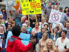 A small group of about 75 protesters still gathered at noon Tuesday on the York Street steps beside the US Embassy even though the original demonstration against white supremacy and racism was postponed until Wednesday at noon.