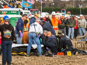 Paramedics tend to a person who was injured after an apparatus used to launch pumpkins into the air exploded at the World Championship Punkin Chunkin Contest in Bridgeville, Del., Sunday, Nov. 6, 2016. (Kyle Grantham/The Wilmington News-Journal via AP)