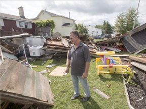 Michel Laurin surveys the damage to his backyard from a category one tornado, Wednesday, August 23, 2017 in Lachute, Que (Ryan Remiorz, The Canadian Press)