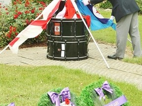 Kerry Horan, Royal Canadian Legion Br. 216 (Petrolia) president, lays the Royal Canadian Air Force Ensign in Brigden in 2011, kicking off Legion Week at the annual Zone A4 Drumhead Service. This year's service is Sept. 17 in Forest. (File photo)