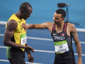 Canada's Andre De Grasse taps Jamaica's Usain Bolt on the chest after finishing second to him in the men's 200m final at the 2016 Olympic Summer Games in Rio de Janeiro, Brazil on Aug. 18, 2016. (THE CANADIAN PRESS/Sean Kilpatrick)