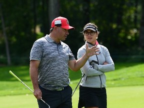 Belend Mozo of Spain walks with Ottawa Senators general manager Pierre Dorion as they take part in the pro-am at the Canadian Pacific Women's Open of the LPGA Tour in Ottawa on Aug. 23, 2017. (THE CANADIAN PRESS/Sean Kilpatrick)