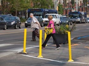 Pedestrians cross Jasper Avenue at 111 Street, Wednesday Aug. 23, 2017. Bump-outs like the one pictured, shorten the crossing distance for pedestrians. The bump-outs are a safety component of the Experience Jasper pilot project. Photo by David Bloom