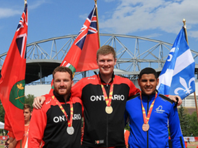 Clinton’s Mackenzie Josie (centre) poses with his competitors and the gold medal he won for his 50.38 m discus throw at the Canada Summer Games earlier this month.