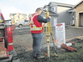 The builder must submit an individual plot plan for each lot, prepared by an engineer or surveyor, showing the specific grading design. (Postmedia News file photo)