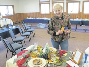 Andrea Smith receives her 1st Place and Best in Show awards at the Creative Colorado Table Setting Contest in Estes Park, Colo. last year. The event was a fundraiser for the Estes Park Museum. (Richard Smith/via AP)