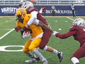 Queen’s Golden Gaels receiver Chris Osei-Kusi tries to get away from Ottawa Gee-Gees Sam Rupcic and Alex Douglas during an Ontario University Athletics football game at Richardson Stadium during the 2016 season. Osei-Kusi is among a group of talented receivers Queen’s has this season. (Whig-Standard file photo)