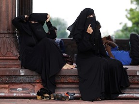 Indian Muslim women rest inside Jama Masjid in New Delhi, India, Tuesday, Aug. 22, 2017. (AP Photo/Tsering Topgyal)