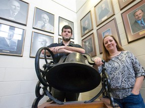 Scott Maclean and Jo-Anne Bishop pose for a photo with a bell from the original Lorne Avenue Public School in this file photo. (Free Press files)