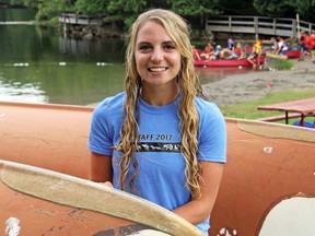 Lauren Hanley, organizer of Storm the Hill 2017 paddling trip, with the two giant voyageur canoes that will take 22 Gould Lake Outdoor Centre staff to Ottawa along the Rideau Canal. Hanley was photographed at the Gould Lake Conservation Area near Sydenham on Thursday. (Steph Crosier/The Whig-Standard)
