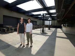 Holly Doty, Youth Opportunities Unlimited campaign manager, left, and Mitra Foroutan, project director, look over the patio of the former GT?s bar where YOU plans to build affordable housing and a youth hub. (MORRIS LAMONT, The London Free Press)