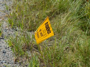 A yellow flag marks the spot along Secord Road where a knife was found Monday after a woman was menaced by a stranger. (Jim Moodie/The Sudbury Star)