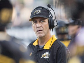 Hamilton Tiger-Cats head coach Kent Austin, watches a play develop against the Winnipeg Blue Bombers during CFL action in Hamilton on Aug. 12, 2017. (THE CANADIAN PRESS/Aaron Lynett)